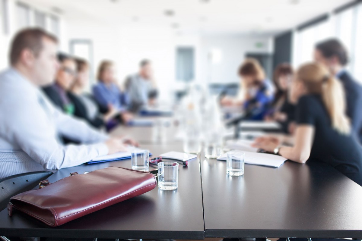 Business people facing each other along a table